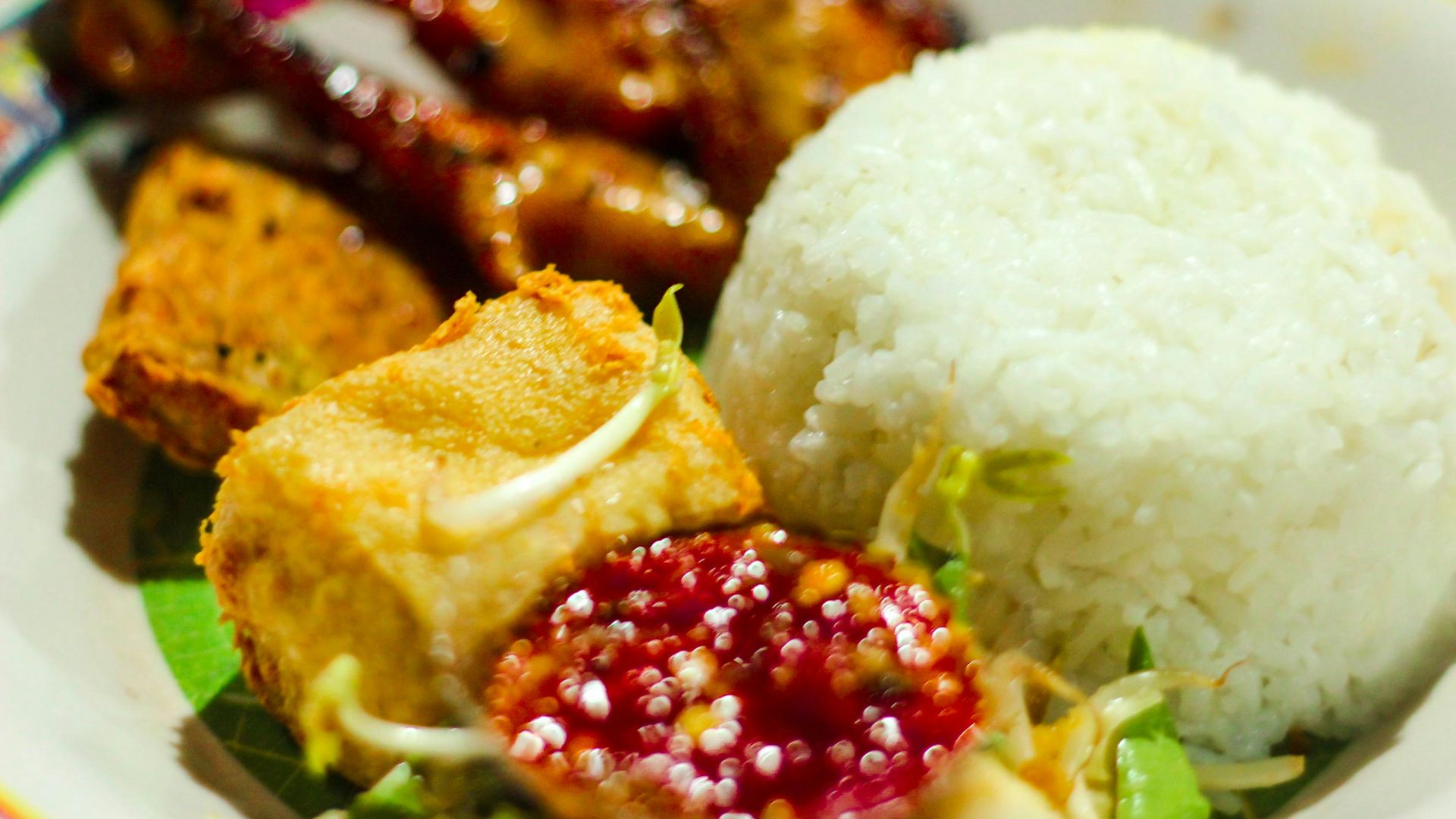 a white plate topped with rice and meat