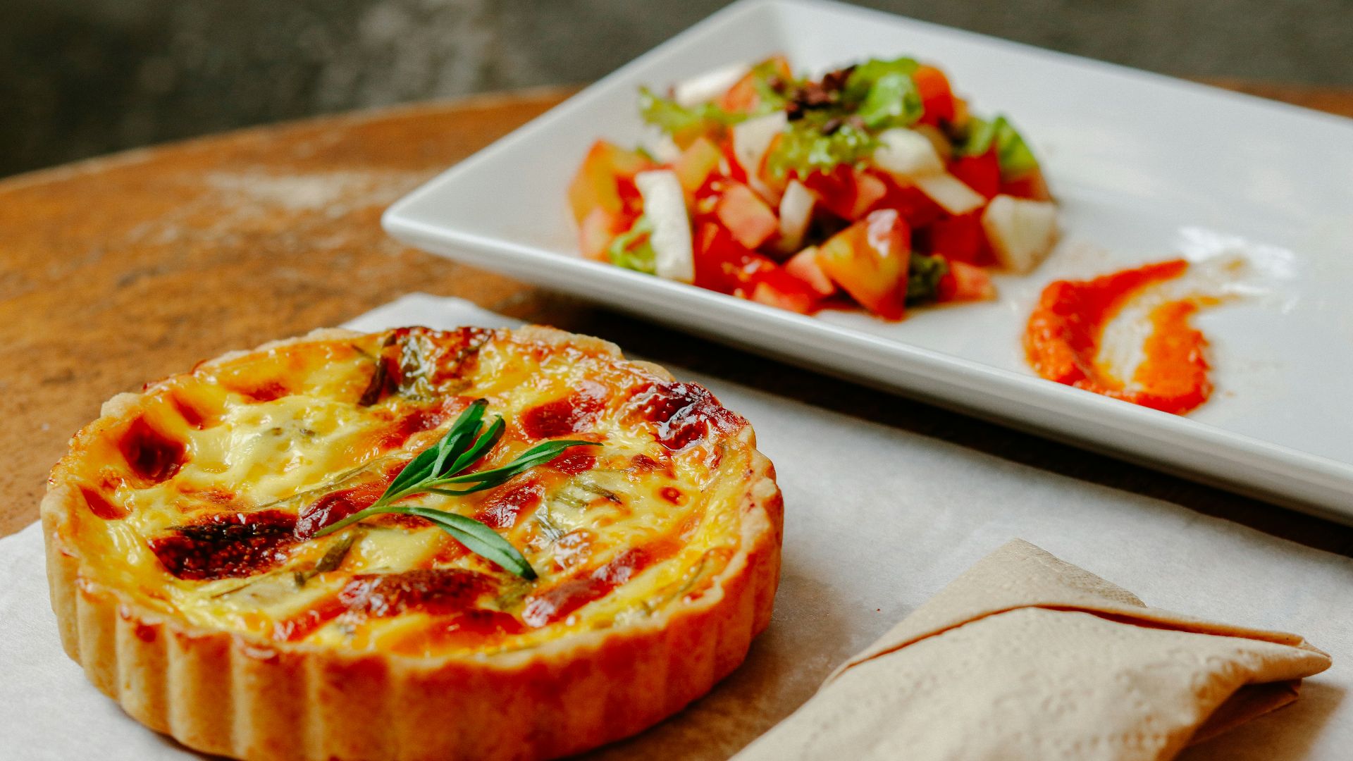 pizza with green leaf on white ceramic tray