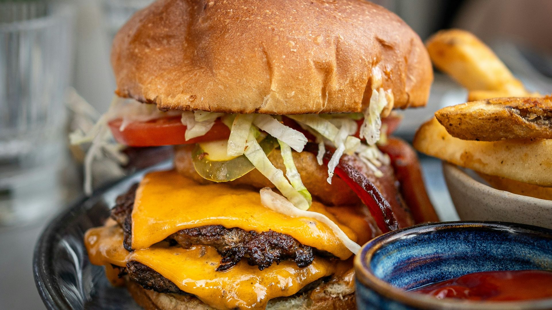 a cheeseburger on a plate with fries on the side