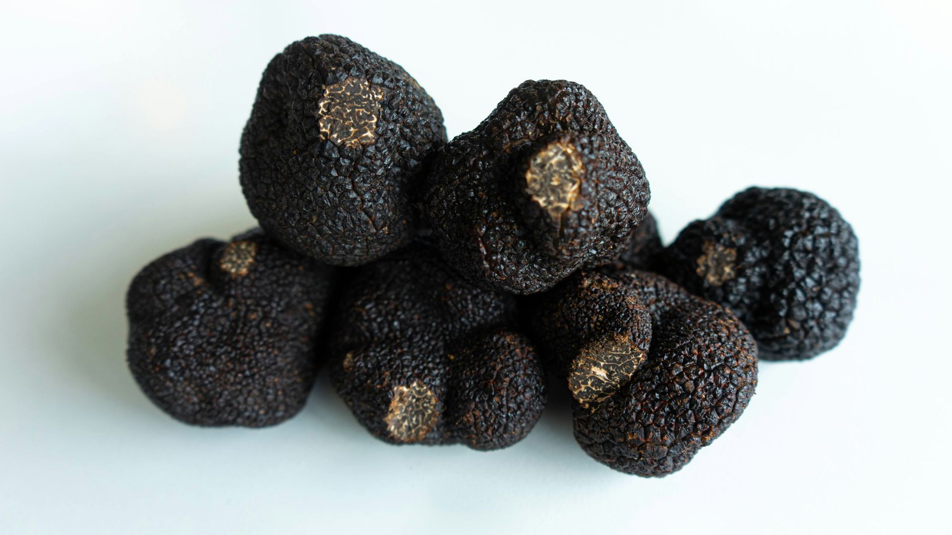 brown round fruit on white surface
