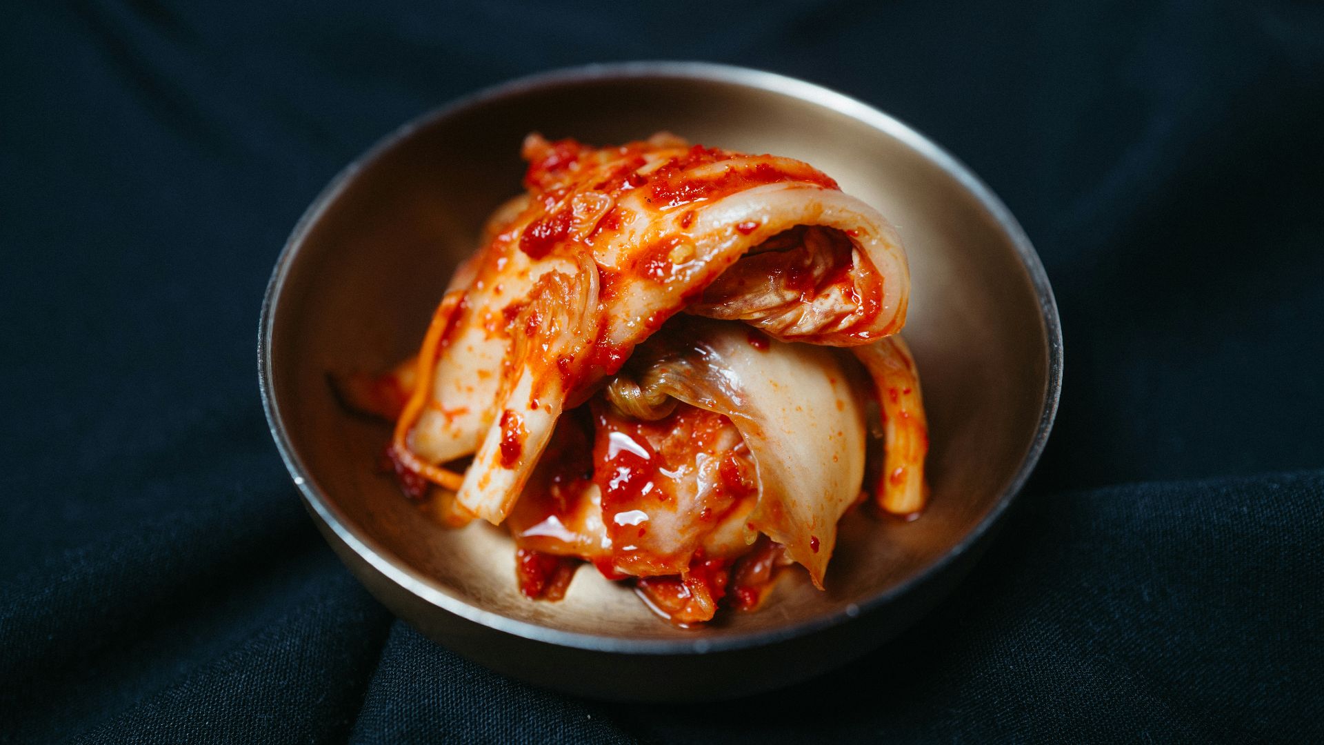 a metal bowl filled with sliced up food