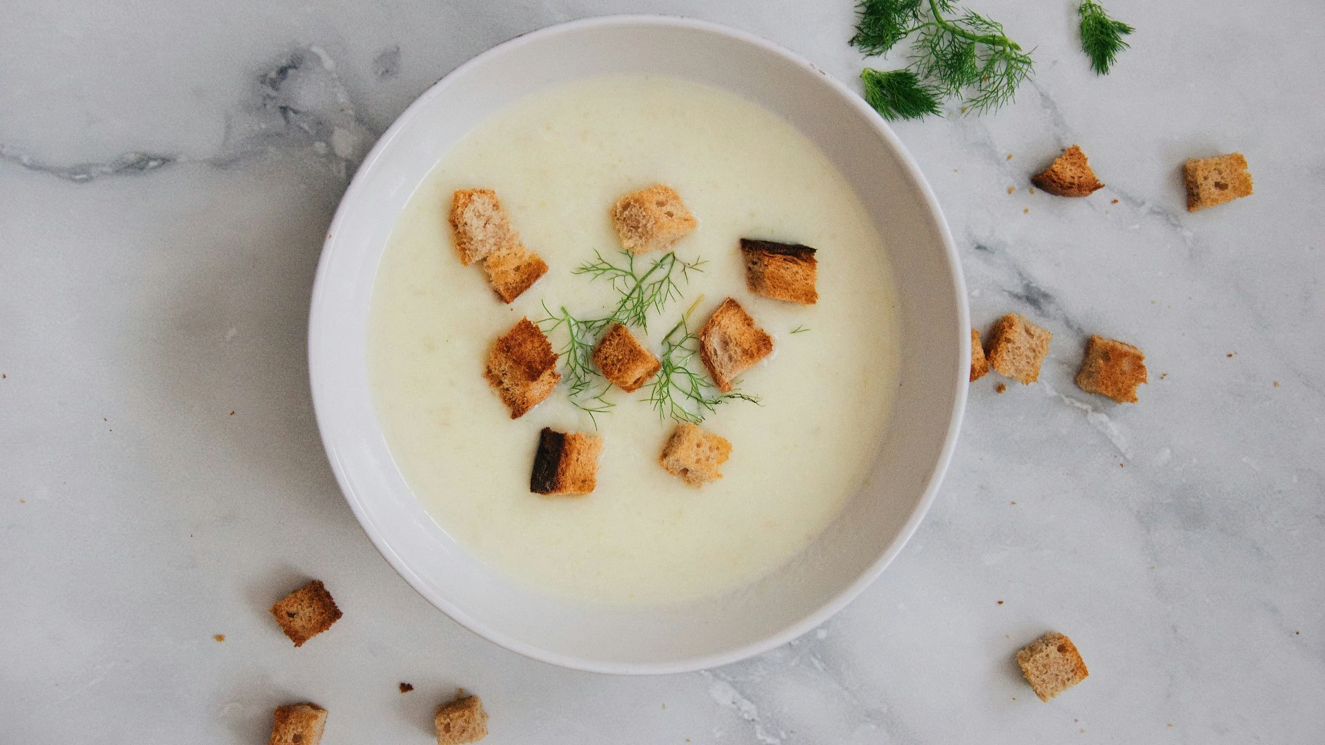 soup with green leaf on white ceramic bowl