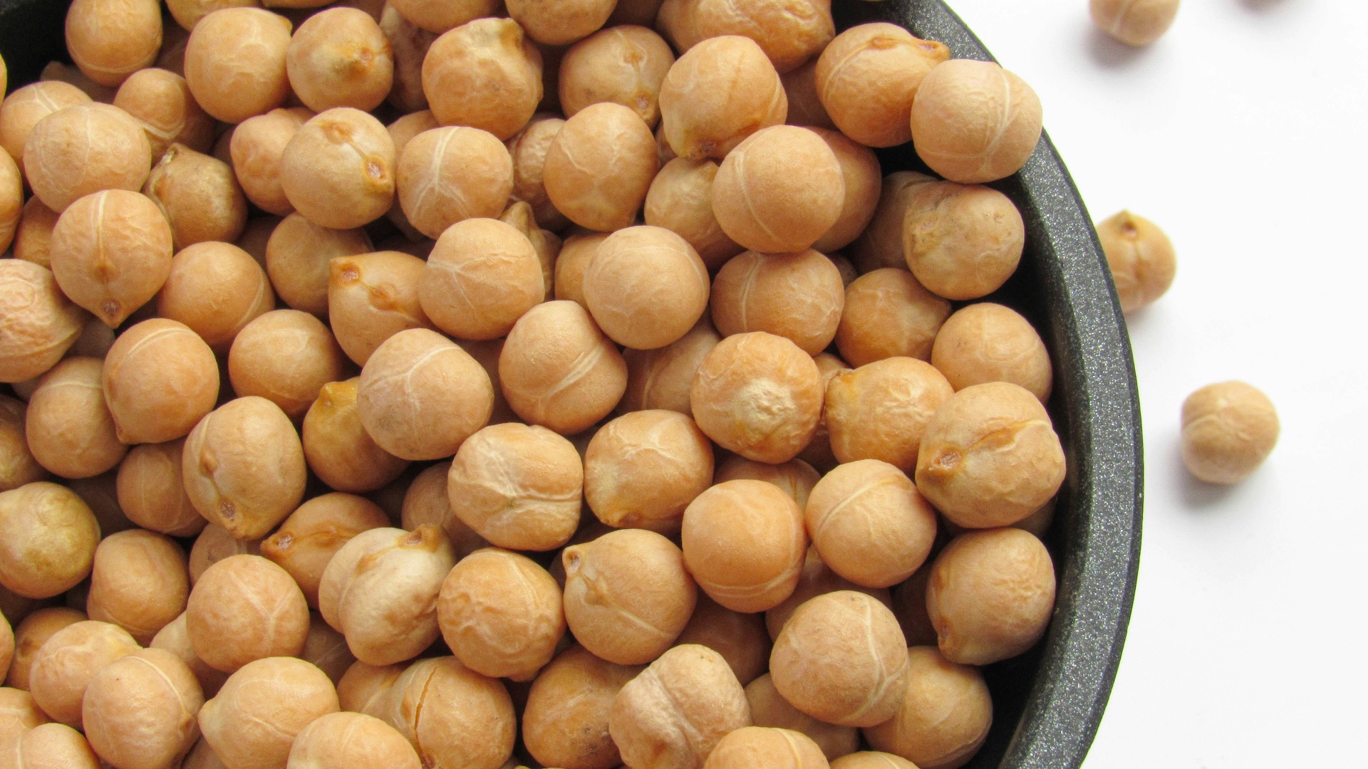 a bowl filled with chickpeas sitting on top of a table