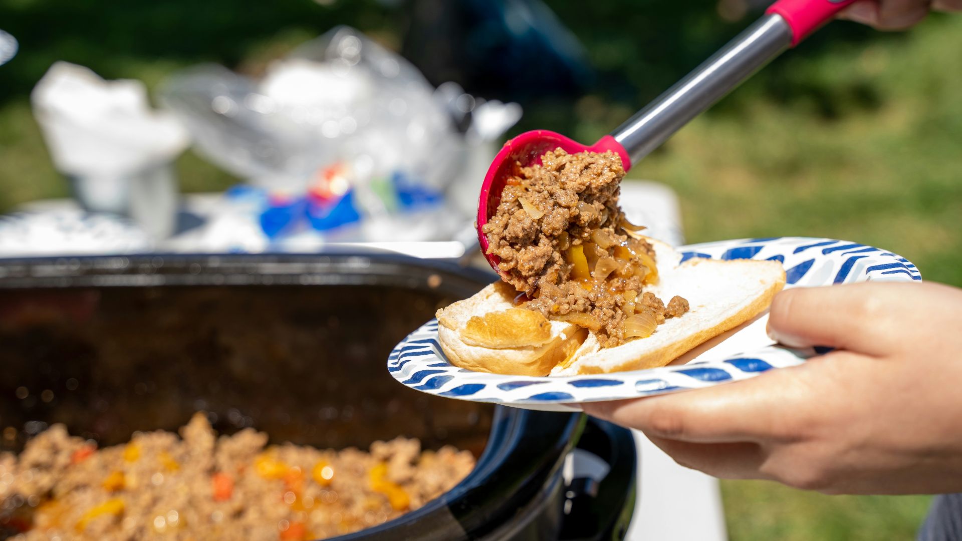 a person cutting a cake with a knife