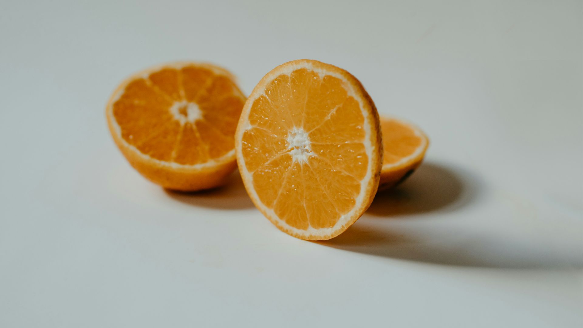 sliced orange fruit on white surface