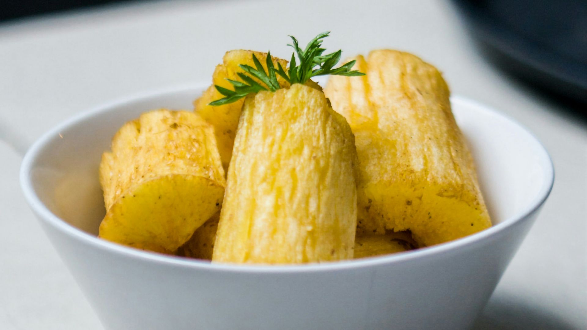a white bowl filled with food on top of a table