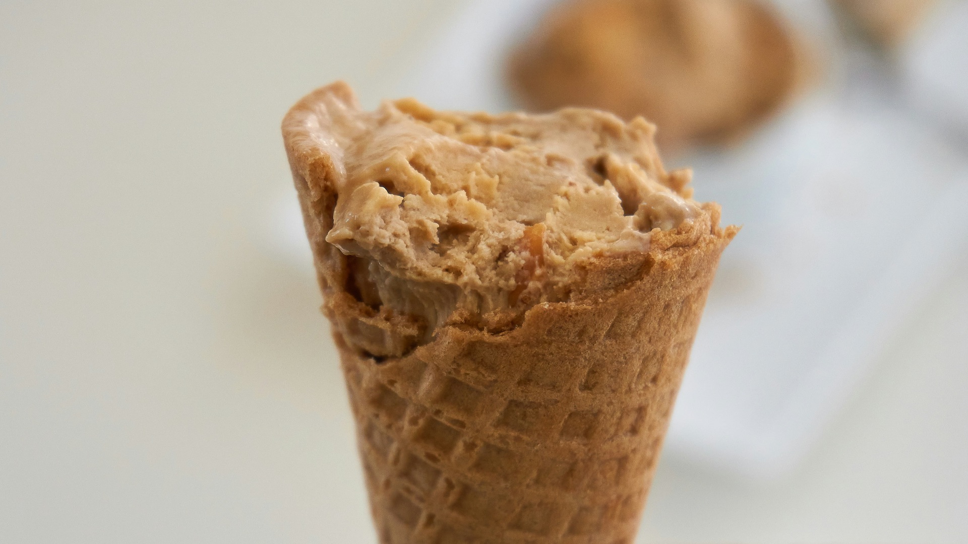 person holding brown ice cream cone