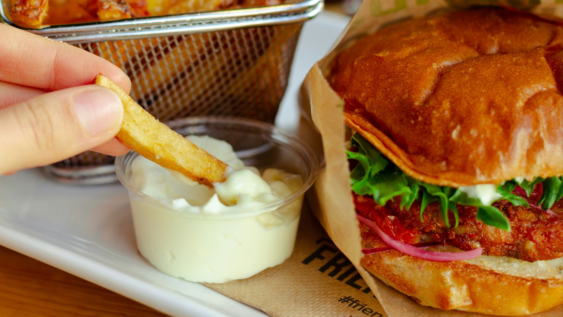 burger with cheese and vegetable on stainless steel tray