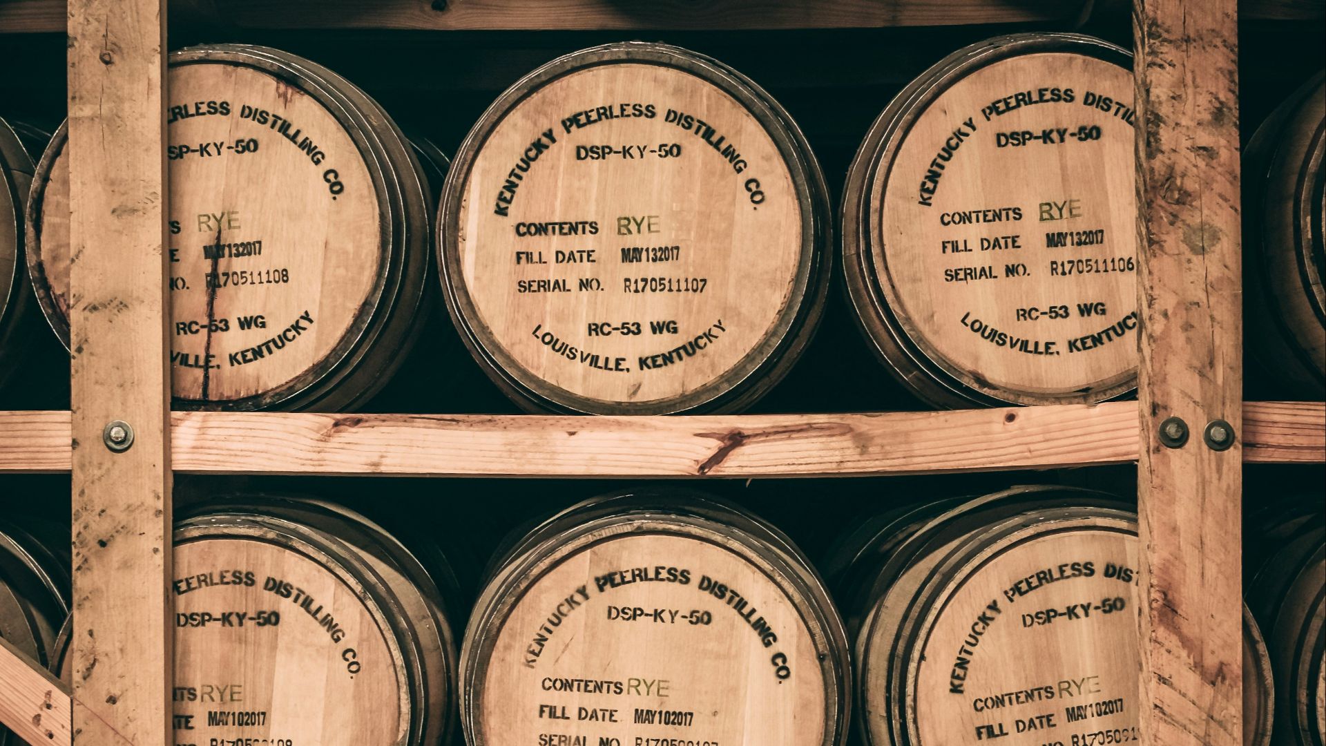a shelf filled with lots of wooden barrels