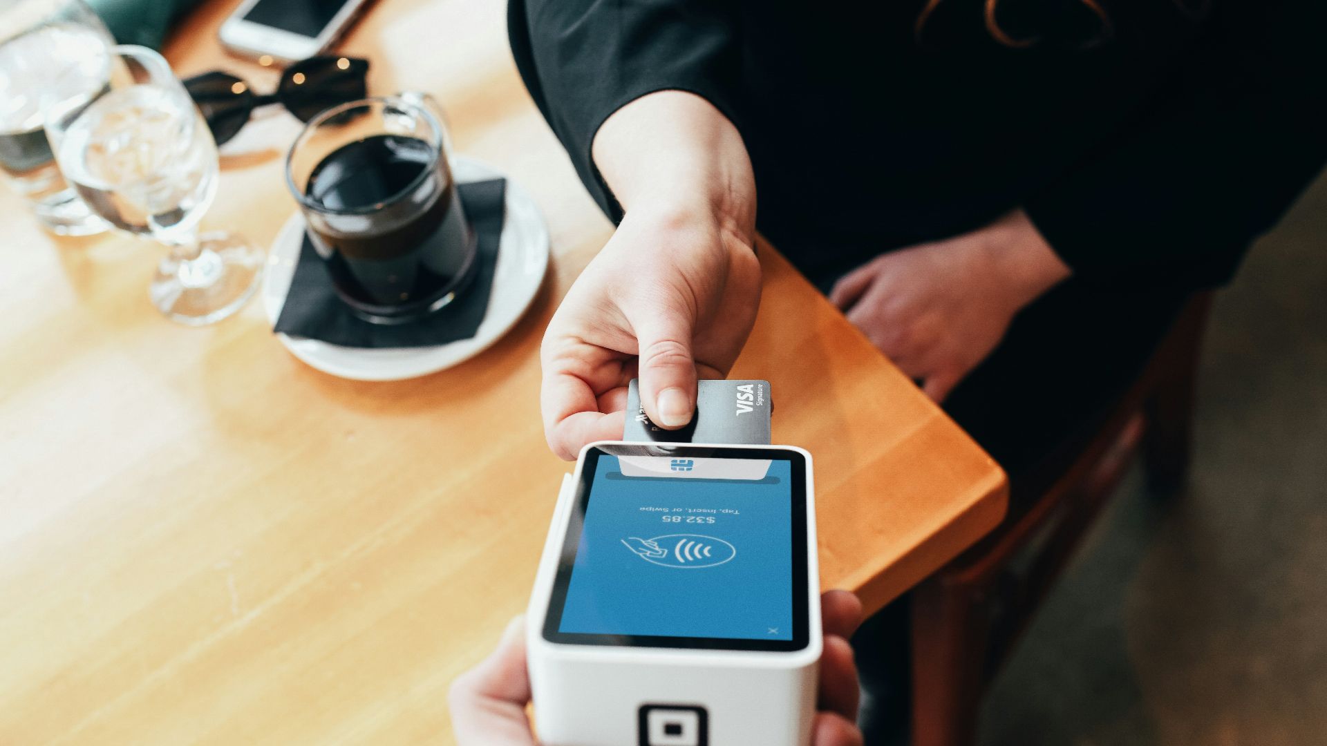 person holding credit card swipe machine