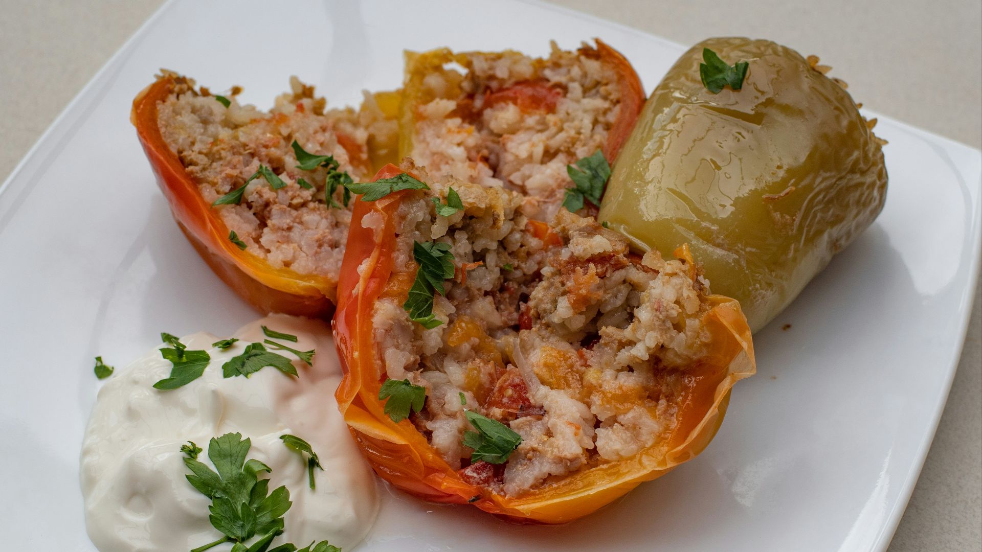 a white plate topped with stuffed bell peppers