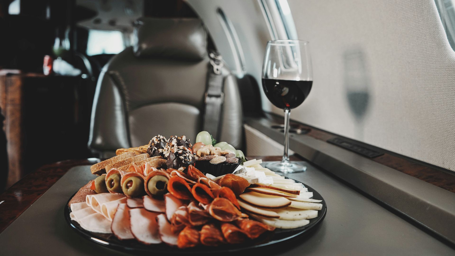 a plate of food and a glass of wine on a table