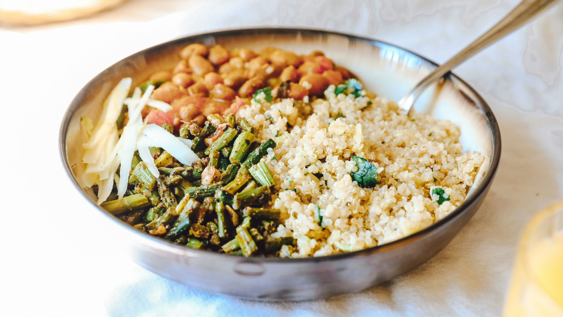 cooked rice with green peas and carrots on stainless steel bowl