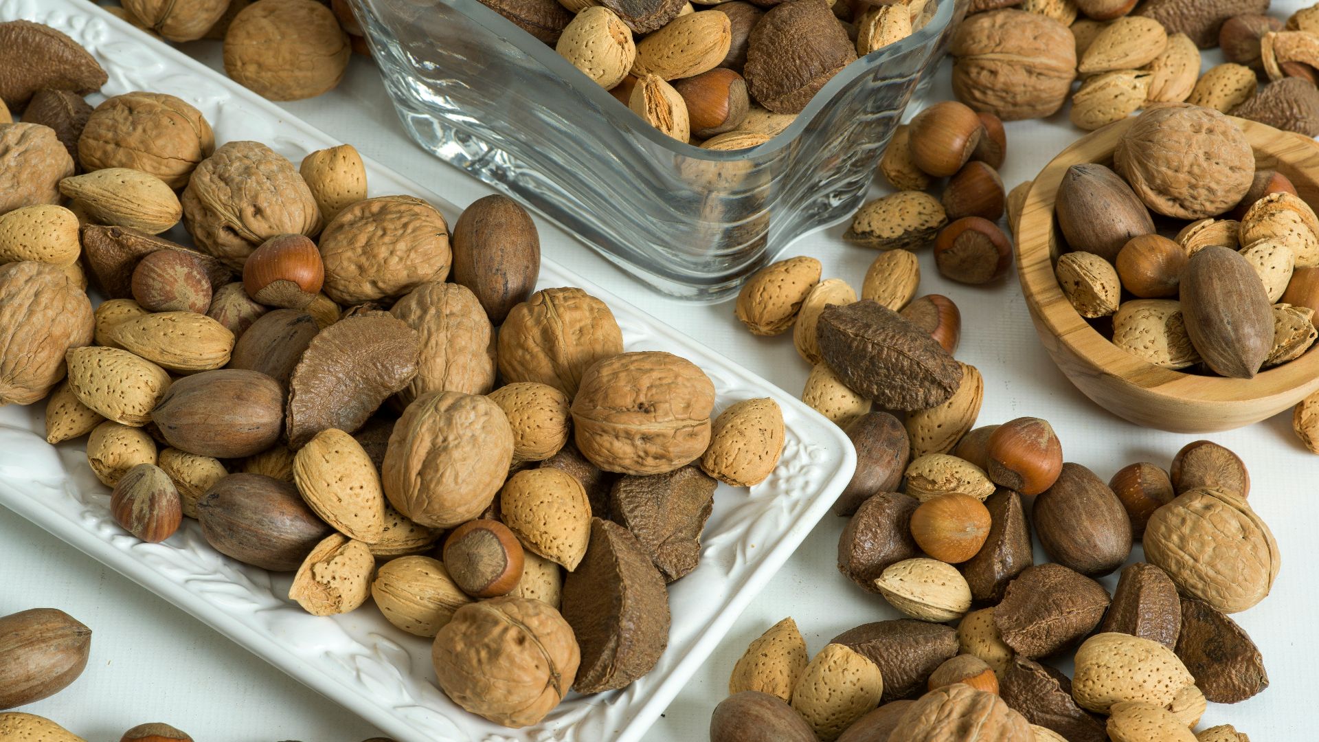 brown almond nuts on white plastic container