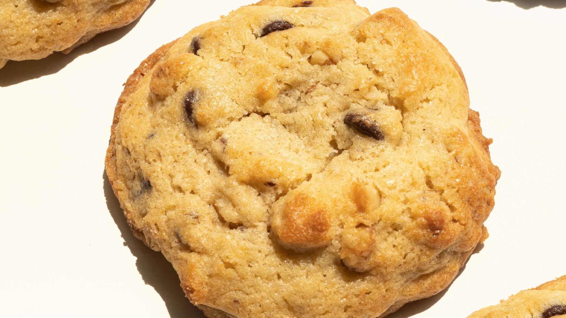 a close up of four chocolate chip cookies