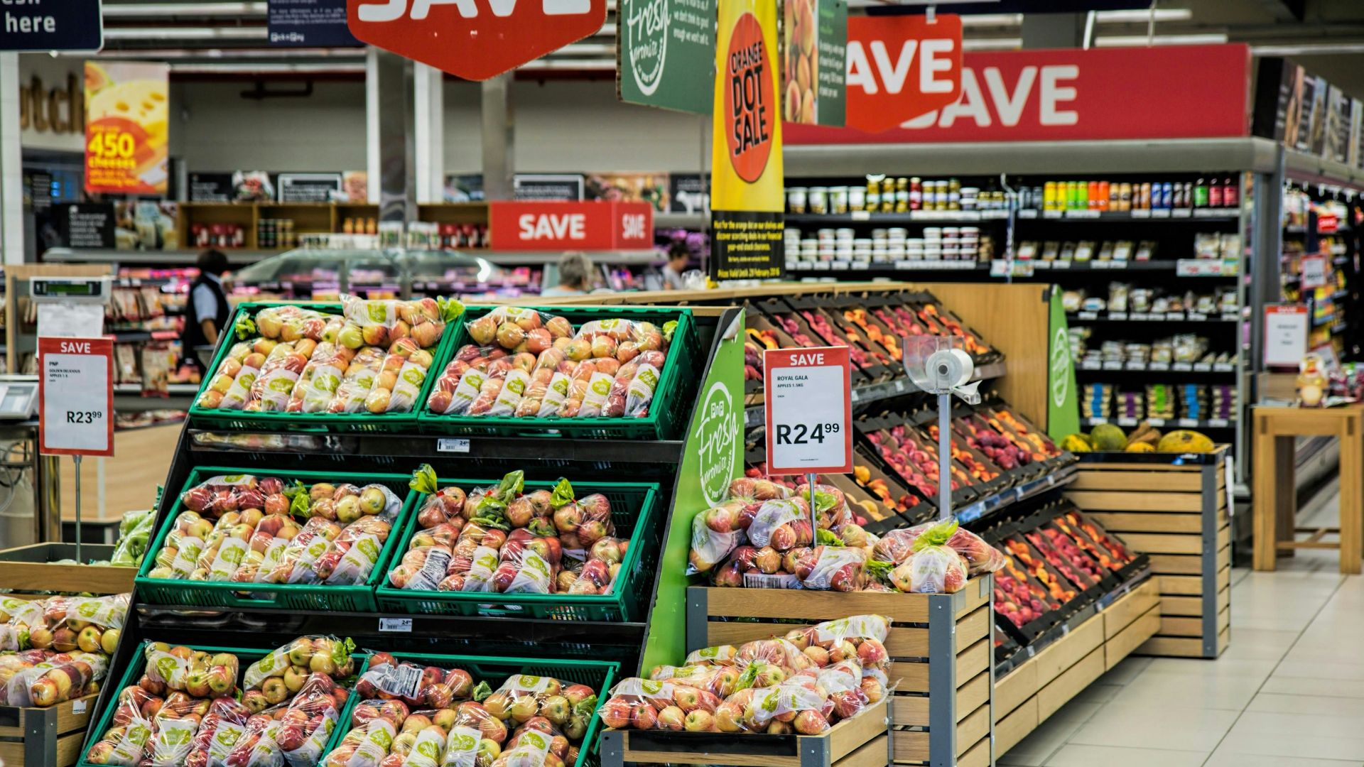 Apples and other produce are displayed in a supermarket.