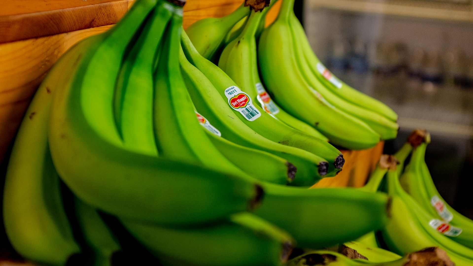 green banana fruit on brown wooden table