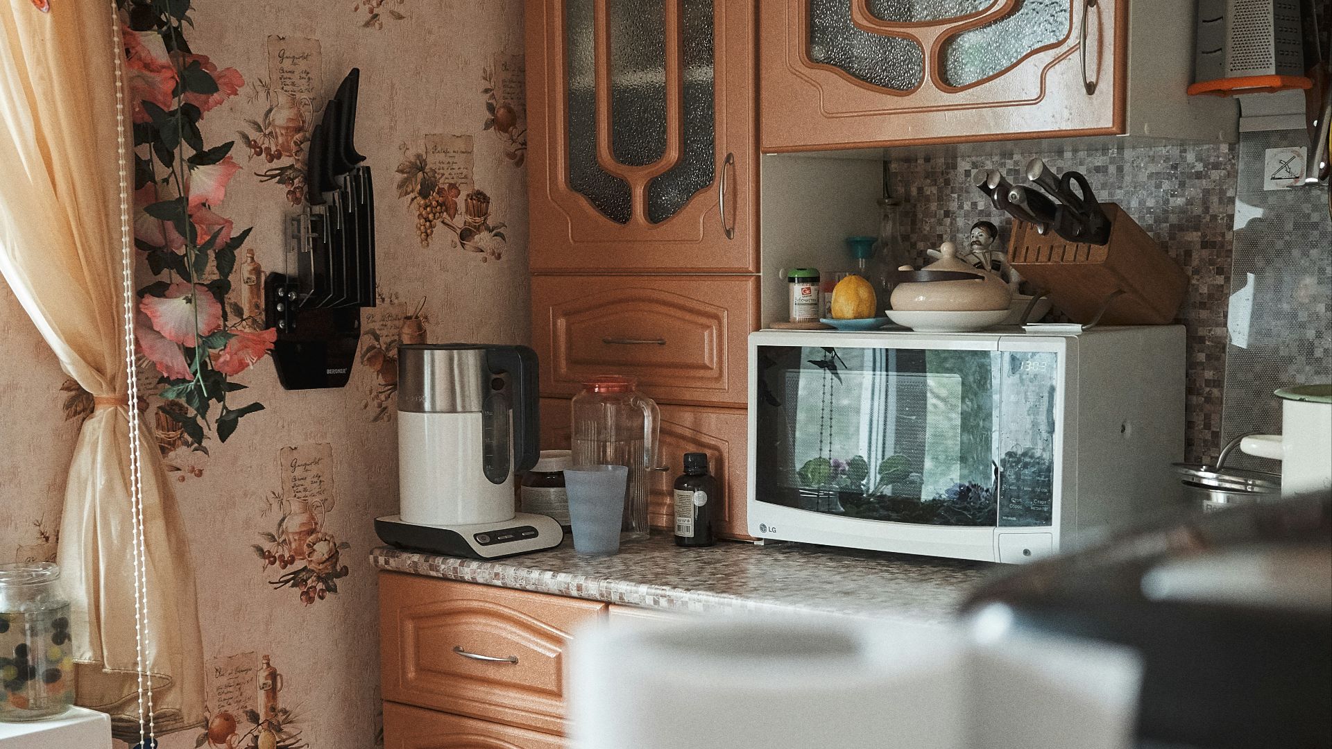 white microwave oven on brown wooden cabinet