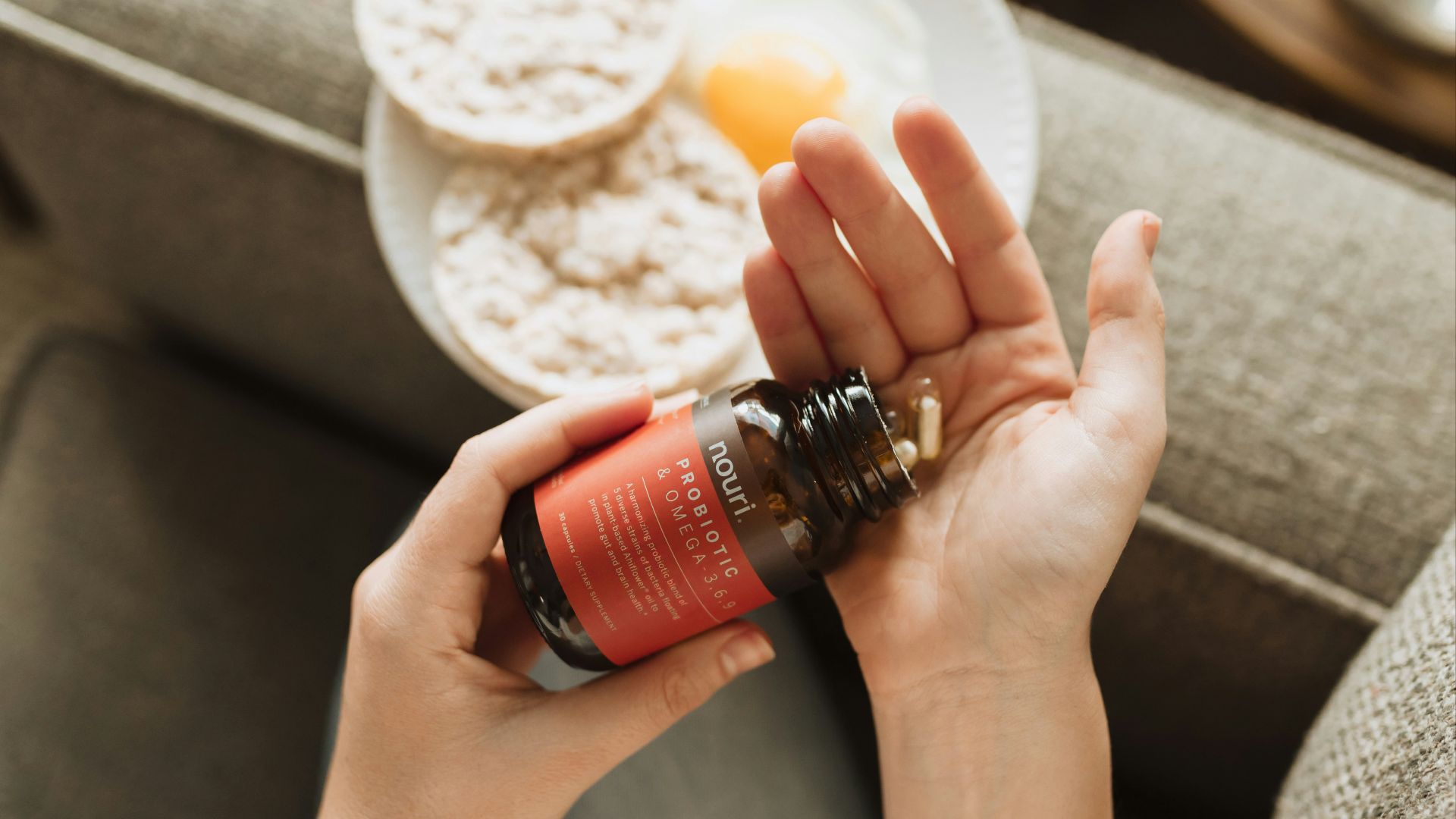 person holding red bottle