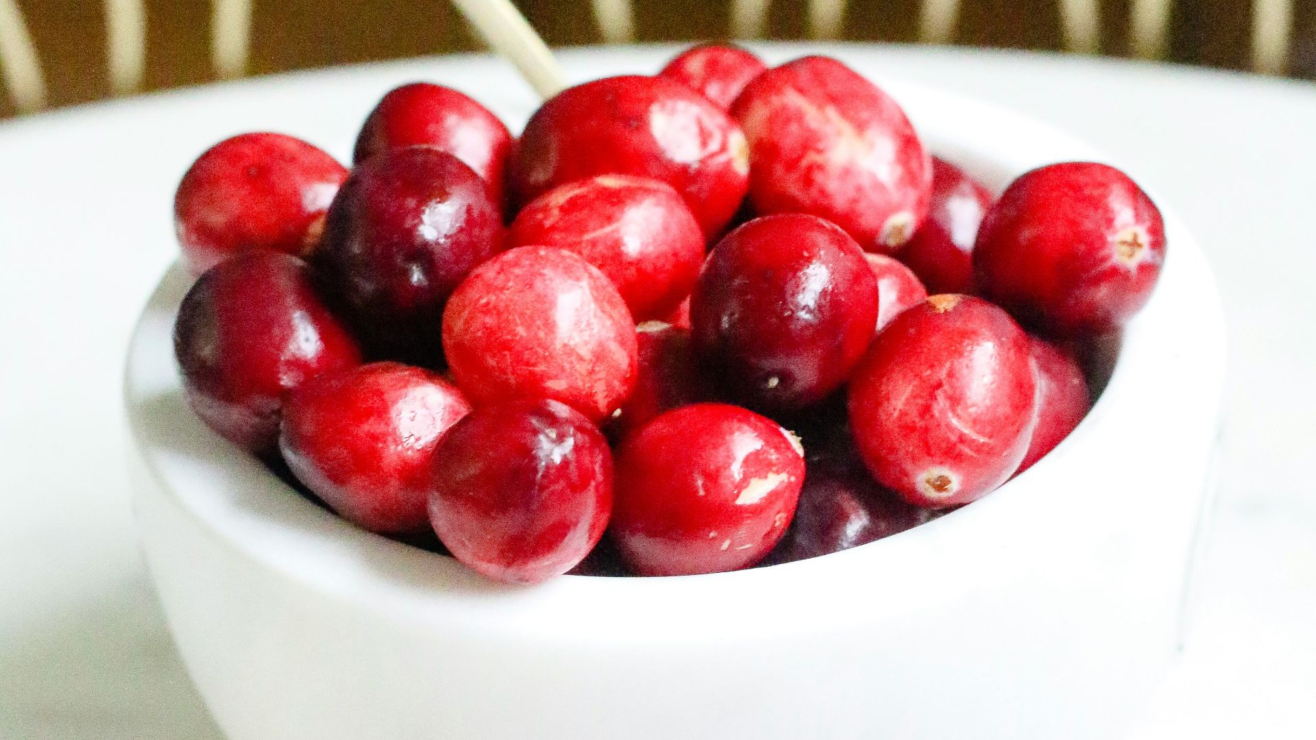 red cherries in white ceramic bowl