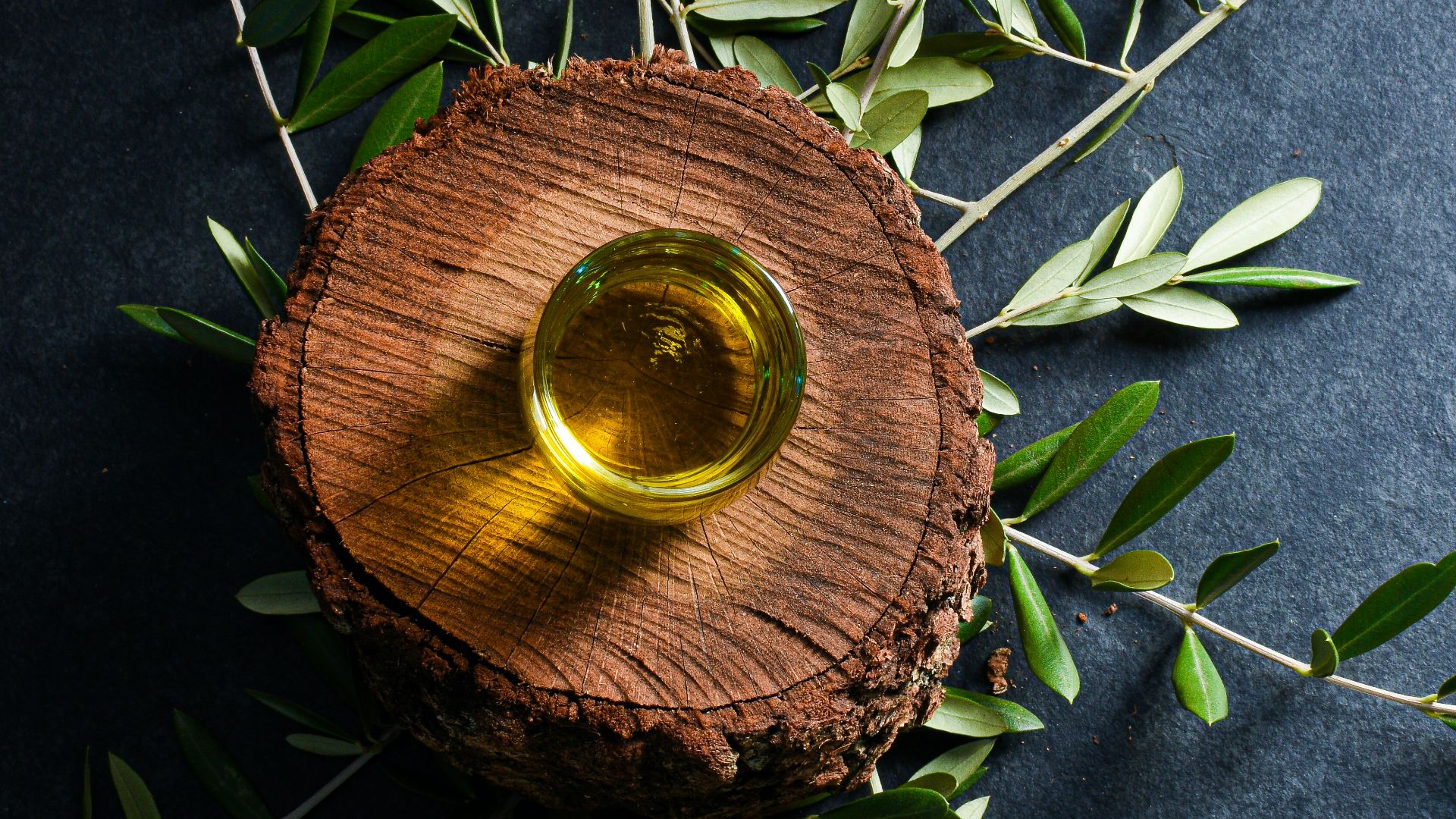 brown round wooden ornament on green leaves