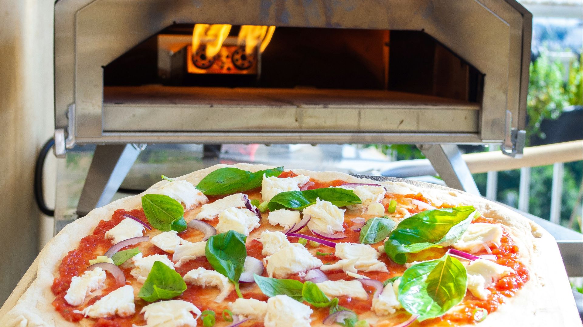 pizza with green and red vegetable on white ceramic plate