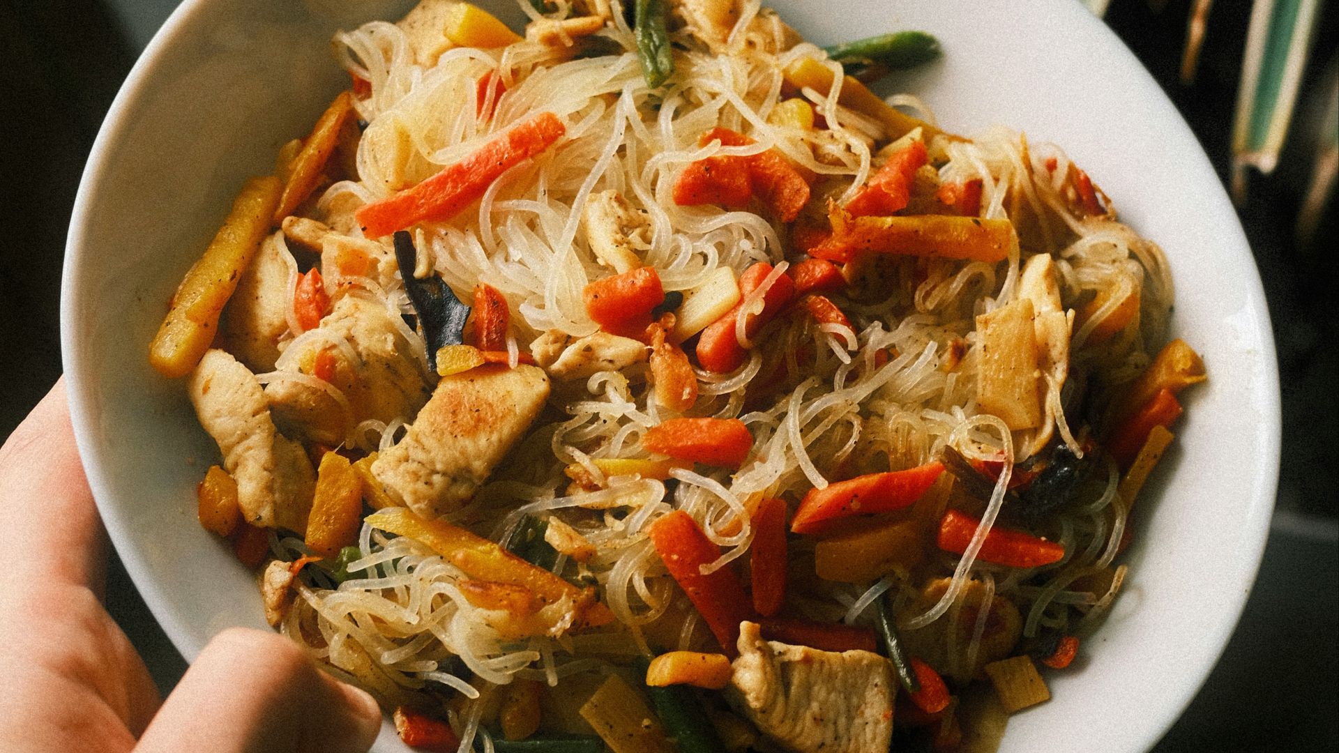 Chicken stir-fry with noodles and vegetables in a bowl