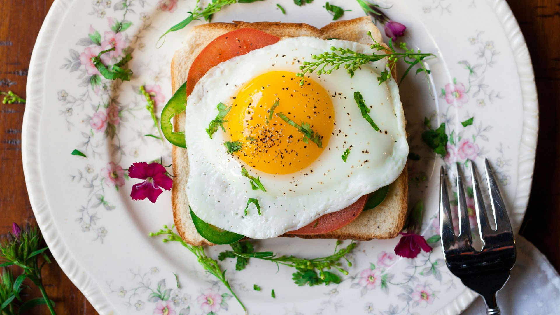 sunny-side up egg with bread beside fork
