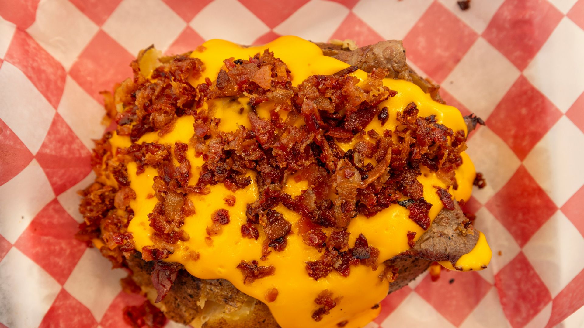 Cheeseburger with bacon on checkered paper