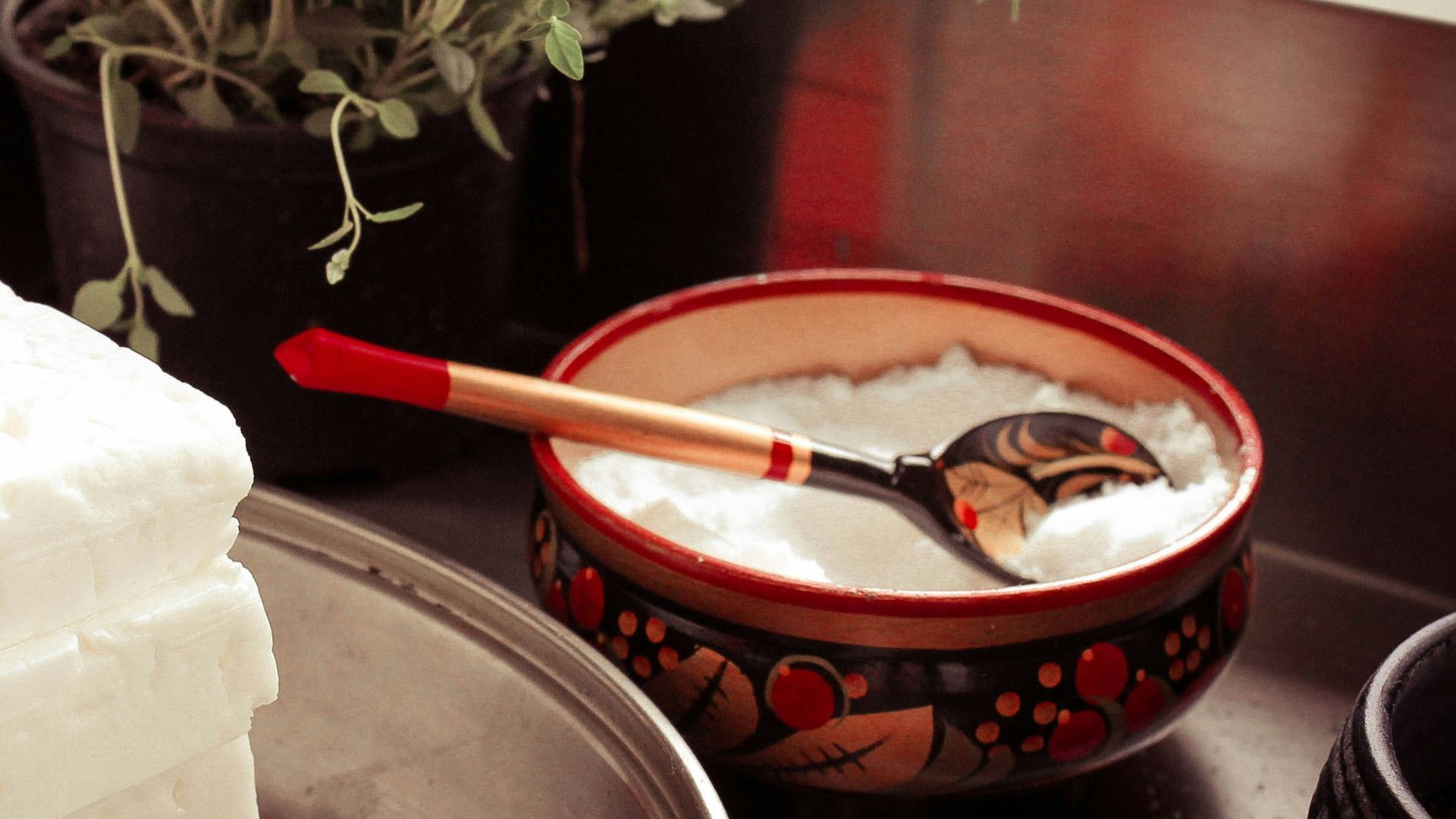 red ceramic bowl on gray spoon