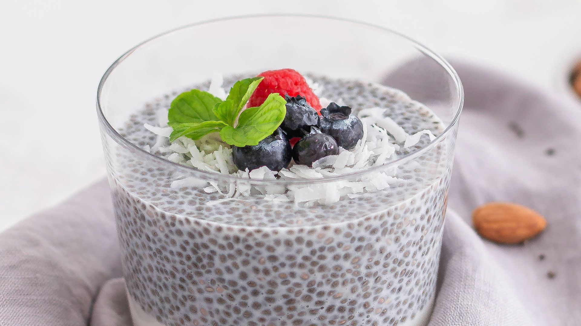 a glass of milk with berries and a spoon