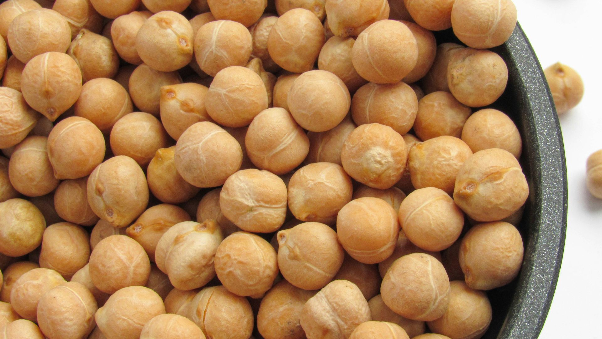 a bowl filled with chickpeas sitting on top of a table