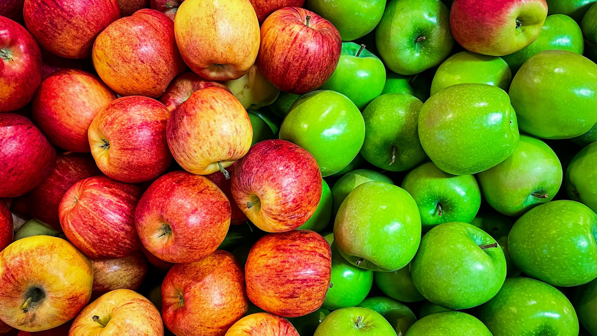 green and red apples on white plastic container