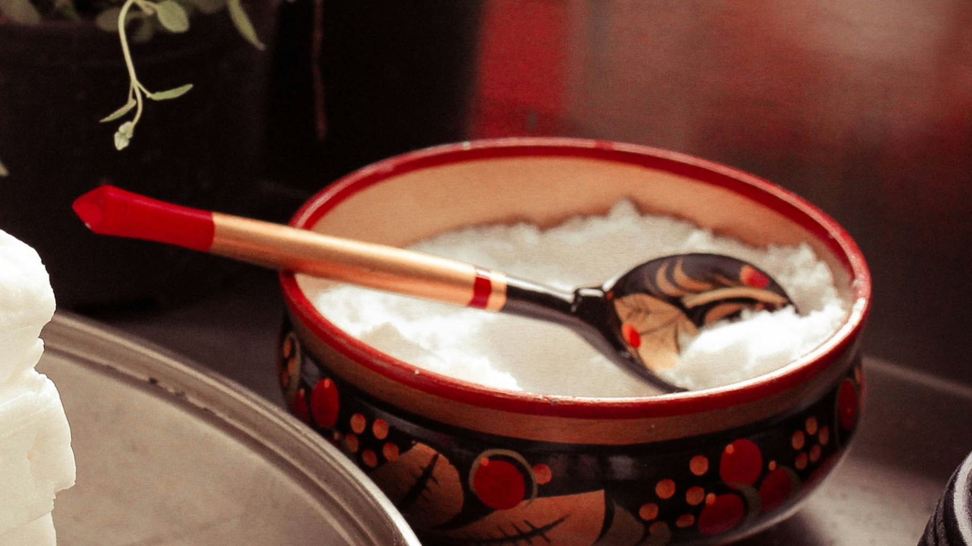 red ceramic bowl on gray spoon