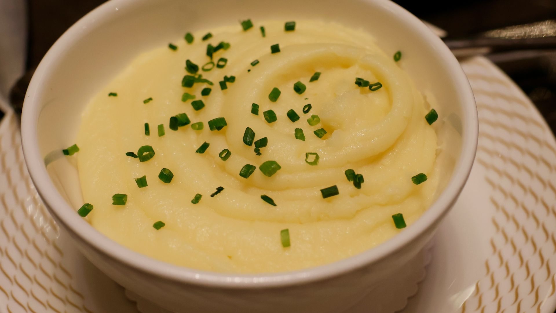 a bowl of mashed potatoes topped with chives