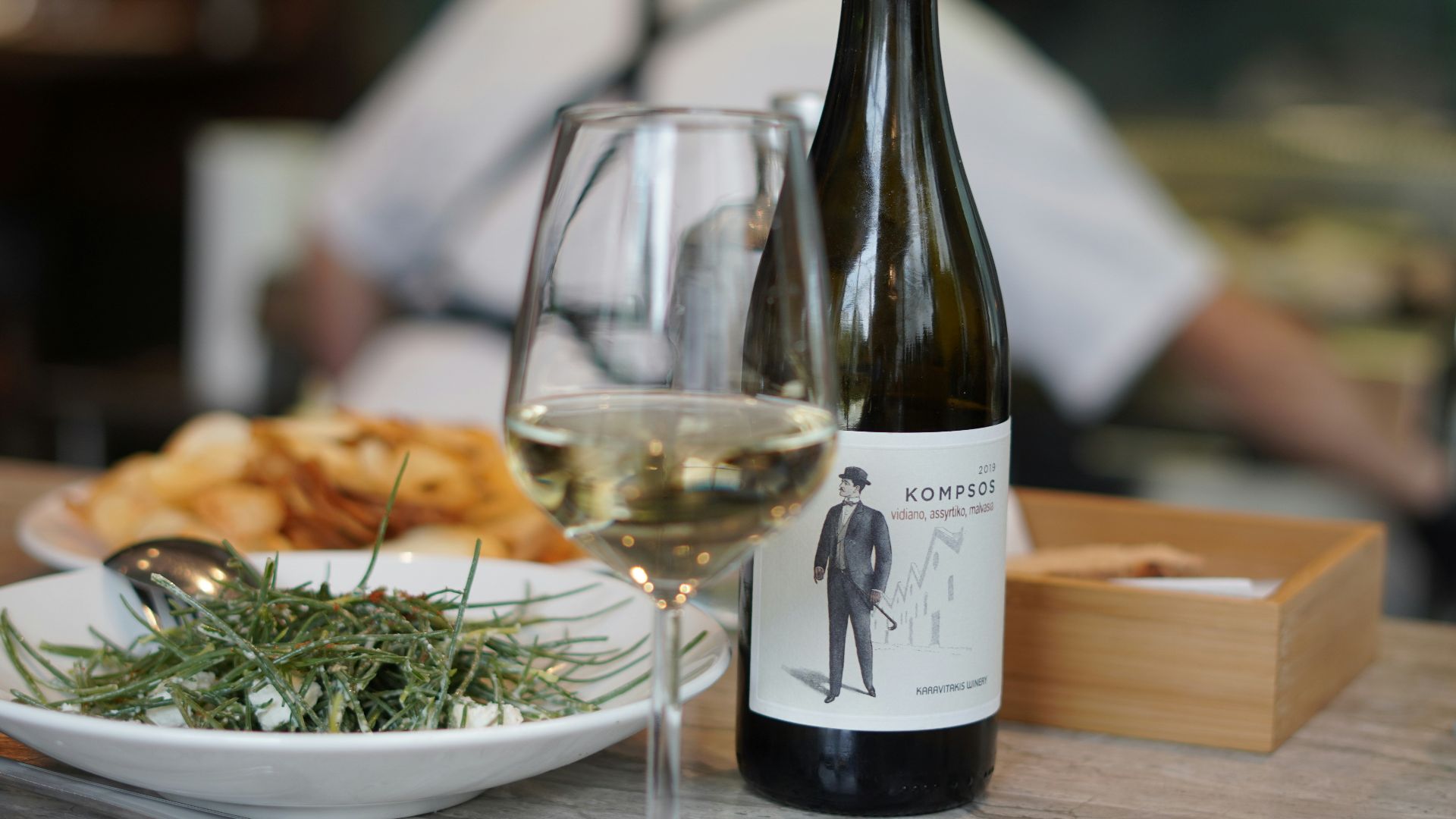 wine bottle beside wine glass on table