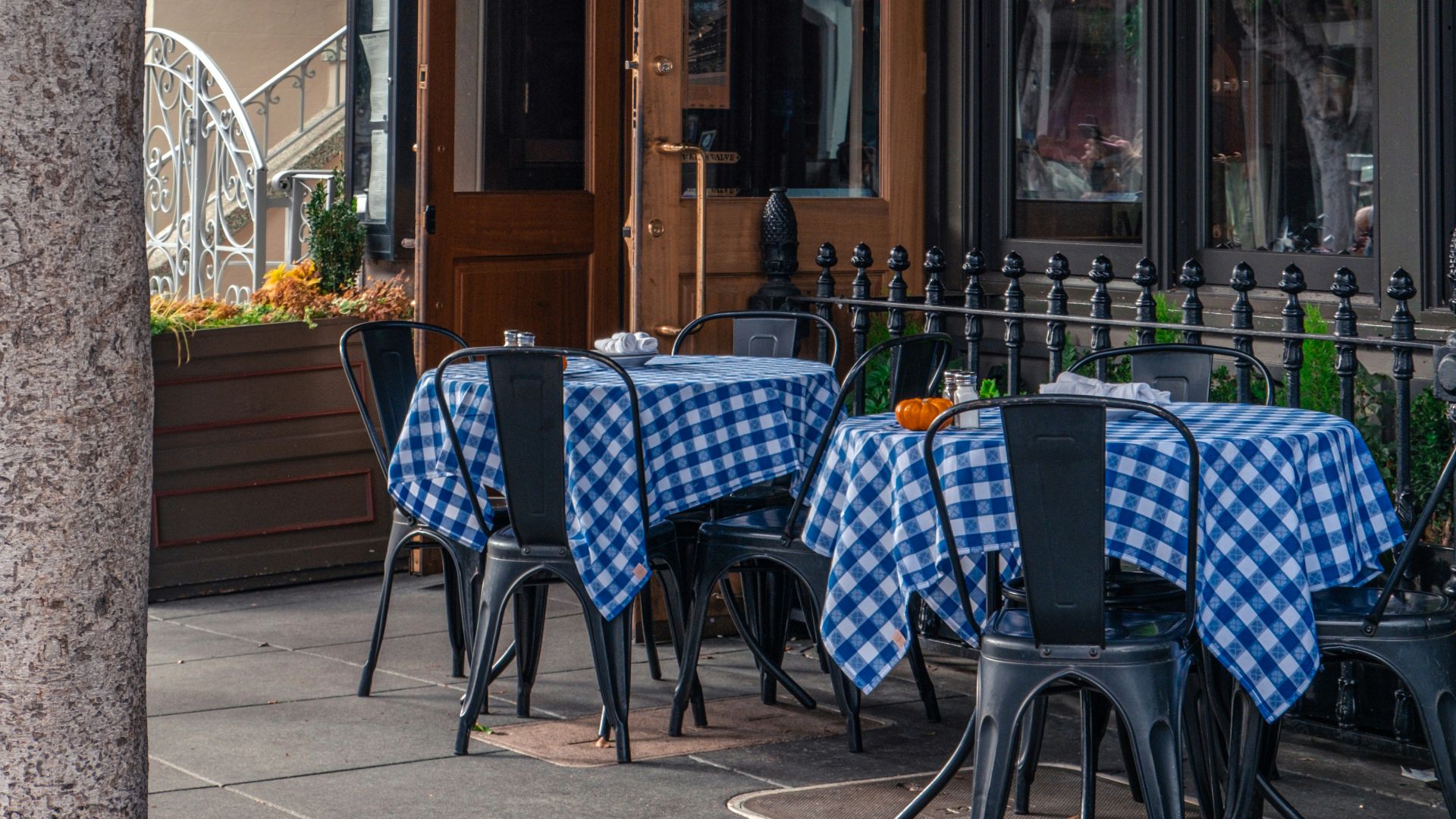A restaurant with blue and white checkered tables and chairs