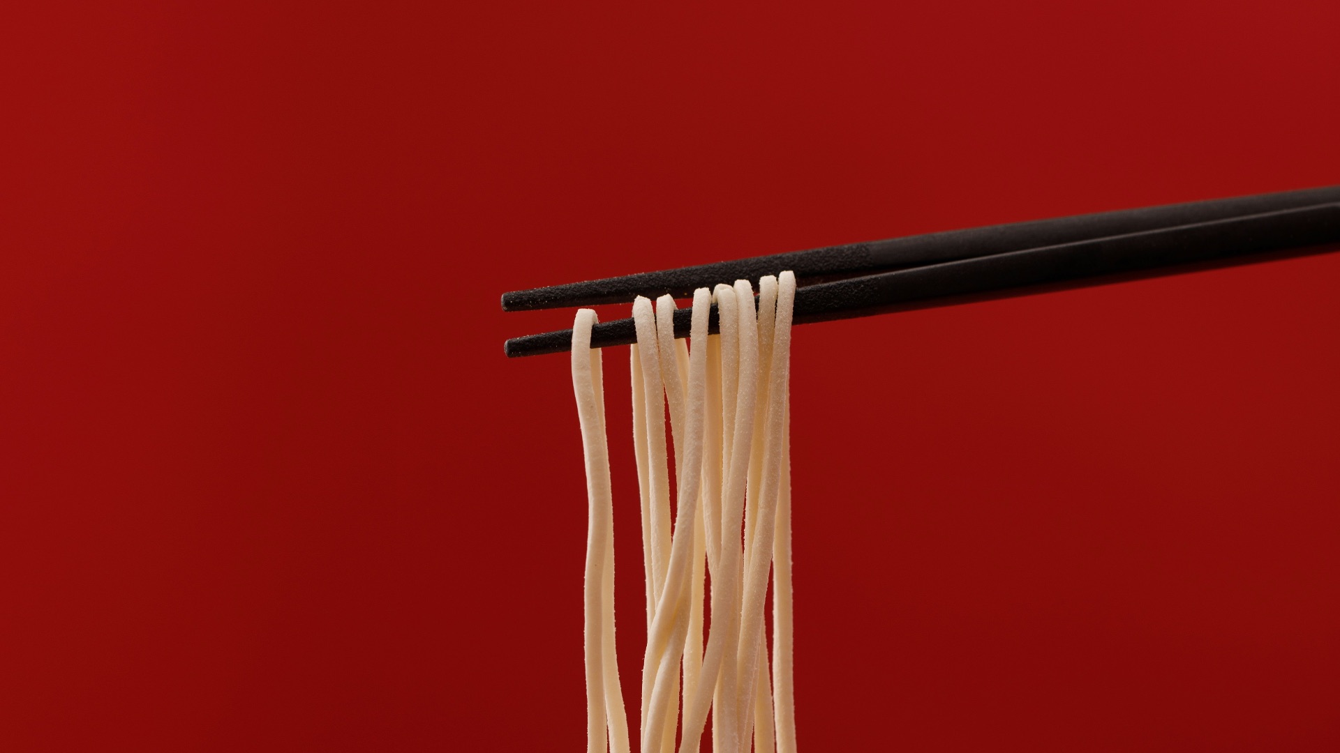 a bowl of noodles with chopsticks sticking out of it