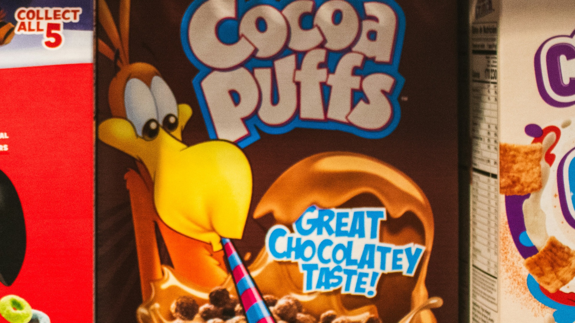 Cereal boxes displayed on a supermarket shelf.