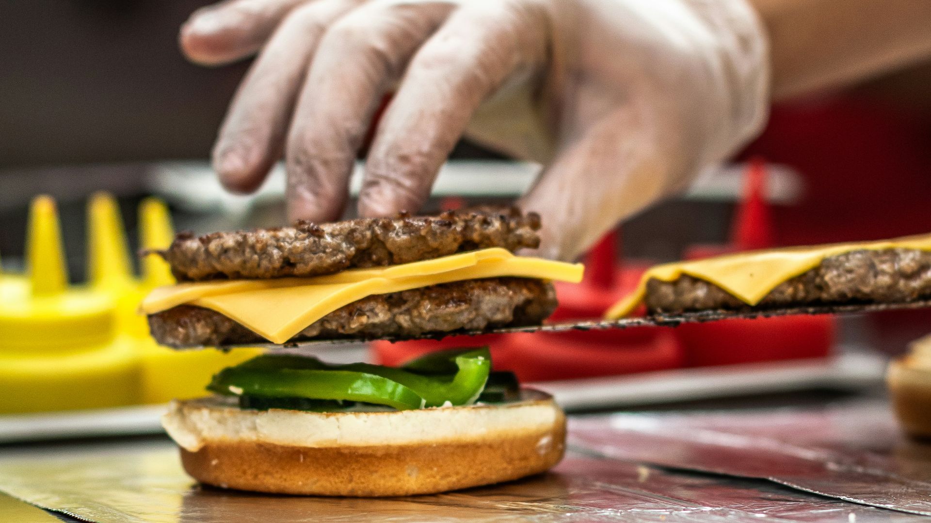 person putting patty on bun