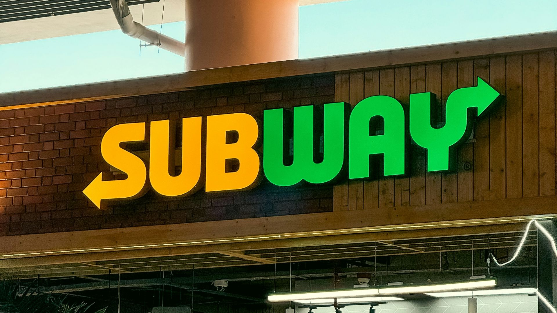 a subway sign above a subway entrance