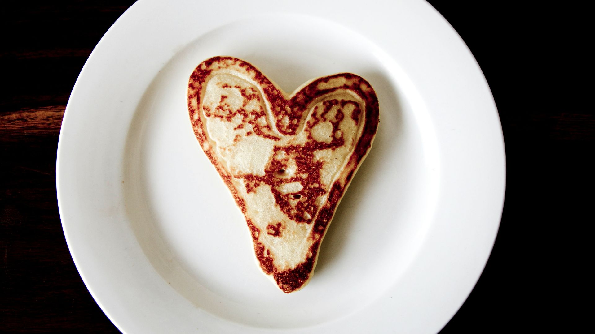 heart-shaped toasted bread on round white ceramic plate