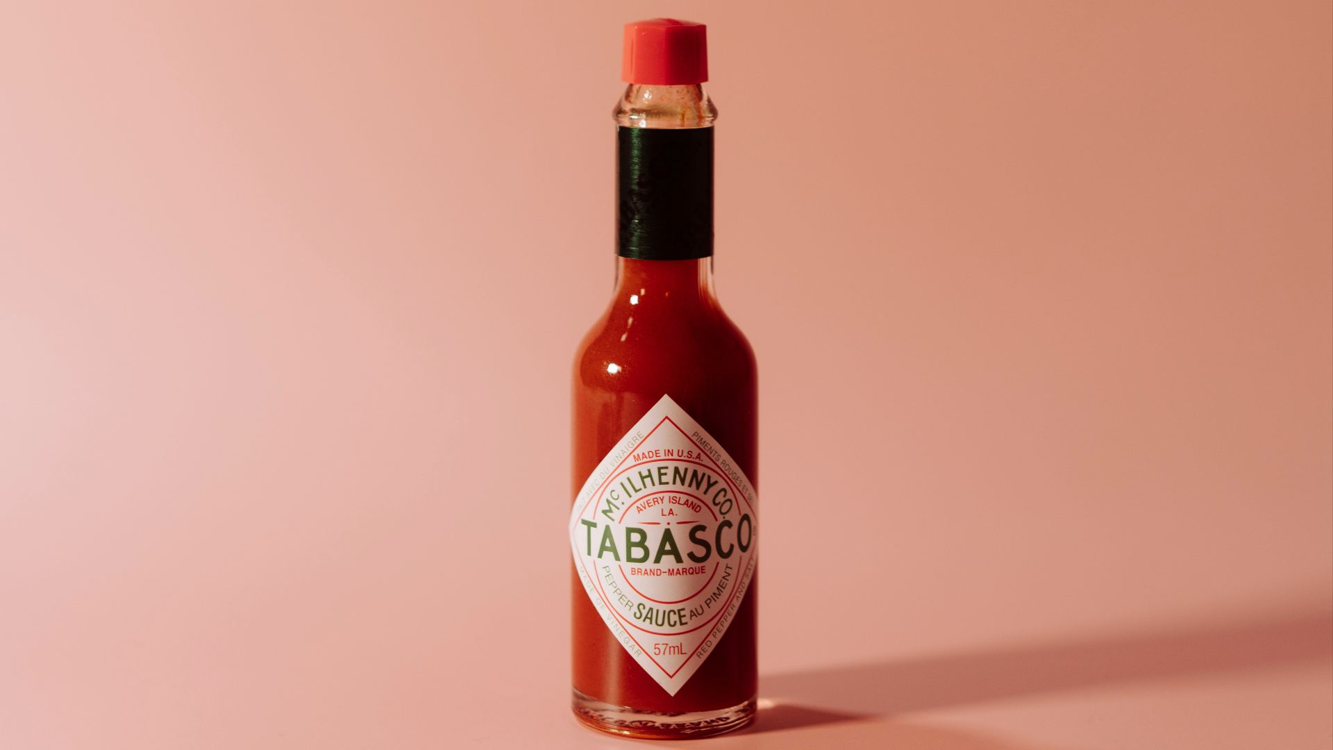a bottle of tabbabata sauce on a pink background