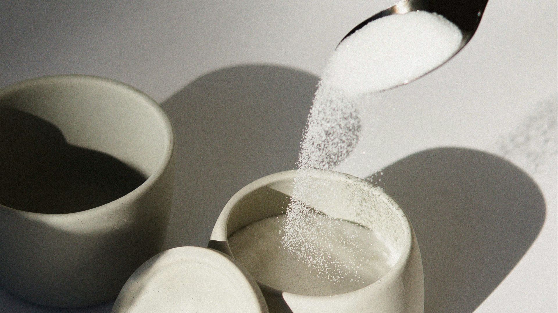 white ceramic mugs on white table