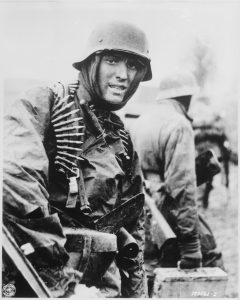 A_Nazi_soldier_heavily_armed_carries_ammunition_boxes_forward_with_companion_in_territory_taken_by_their..._-_NARA_-_531230.tif-240x300.jpg