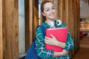 woman-standing-in-hallway-while-holding-book-1462630-300x200.jpg