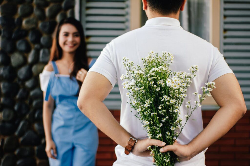 man-holding-baby-s-breath-flower-in-front-of-woman-standing-935789-1024x682.jpg.optimal.jpg