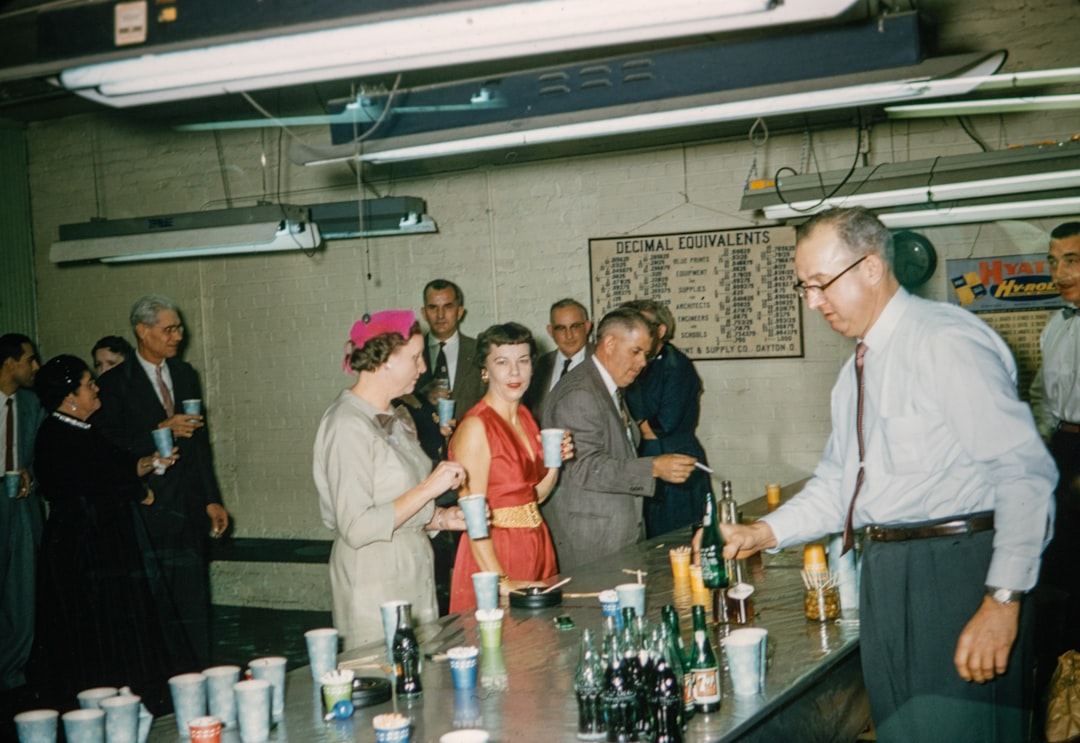 a group of people standing around a bar