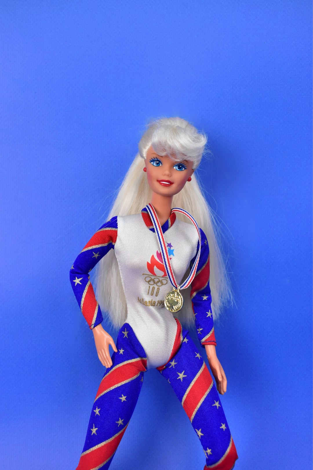 A barbie doll with a medal around her neck