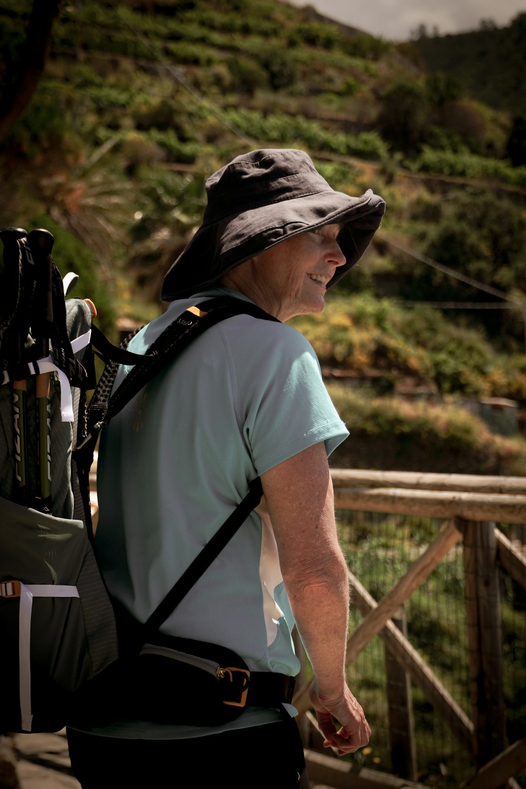 A person with a backpack and a golf bag